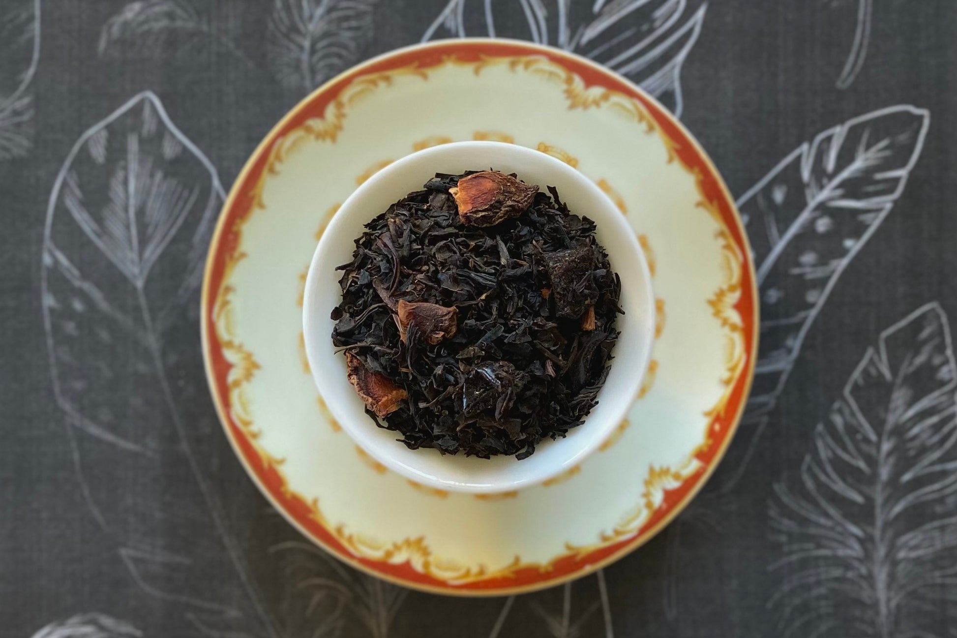 Teacup full of black tea leaves and star anise