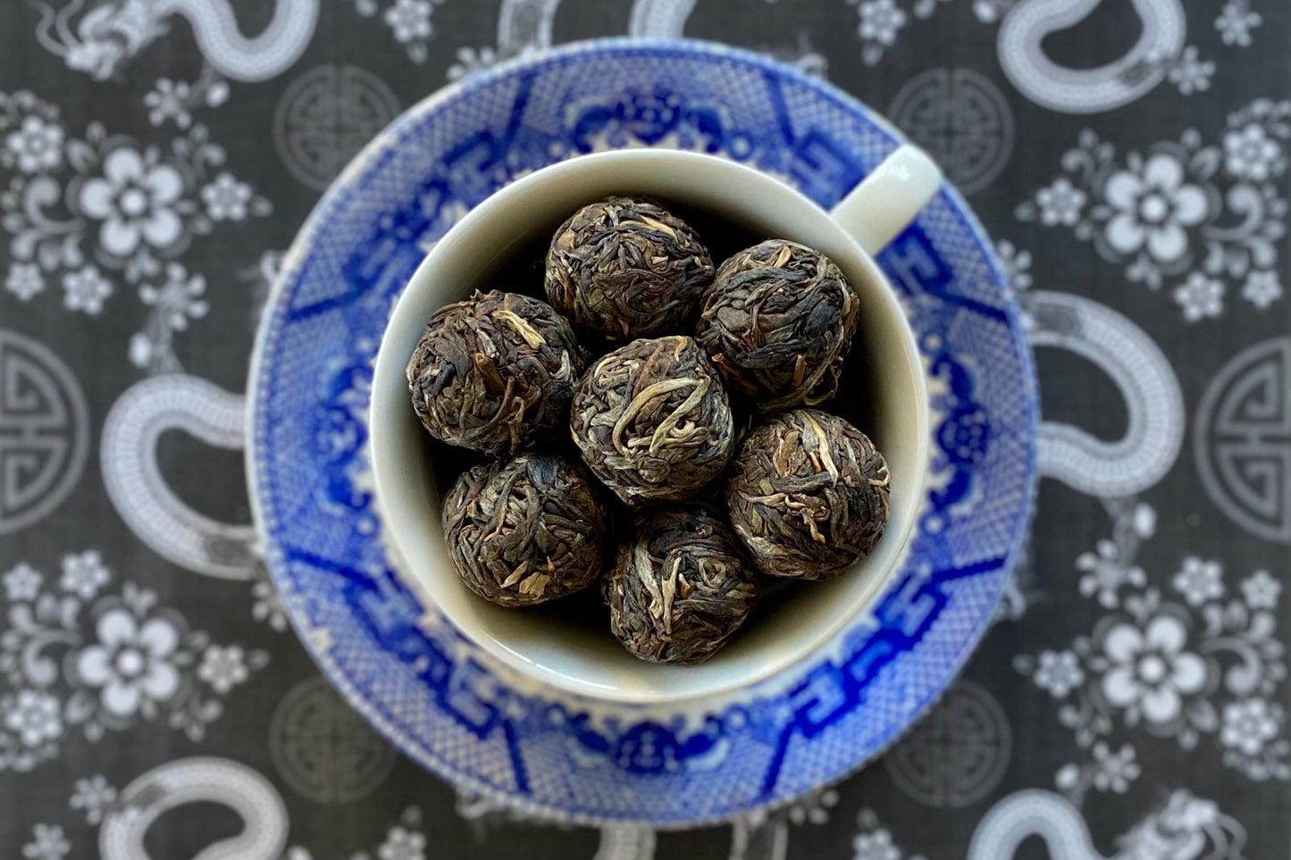 Teacup full of unwrapped tea balls