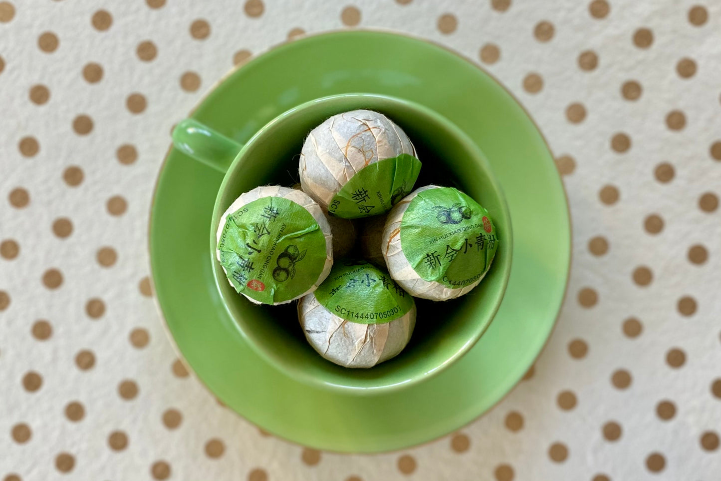 Teacup full of wrapped tea oranges