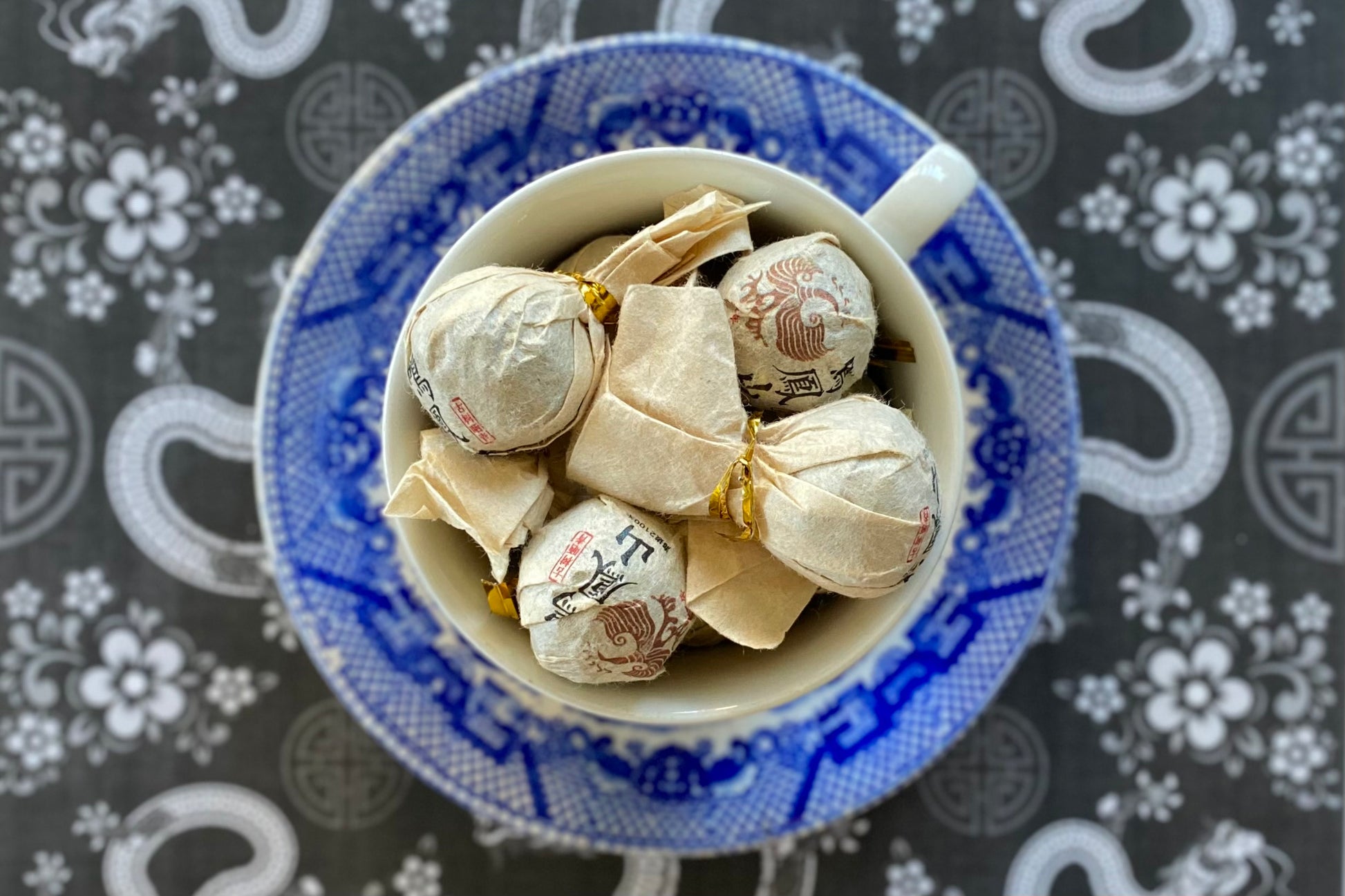 Teacup full of wrapped tea balls