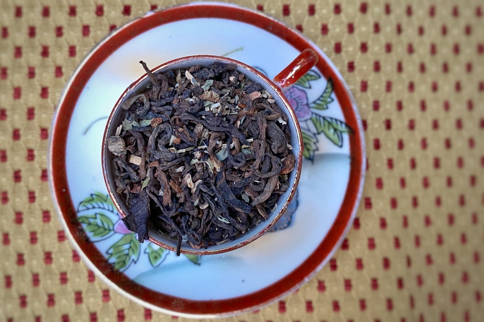 Aged tea and herbs in a teacup