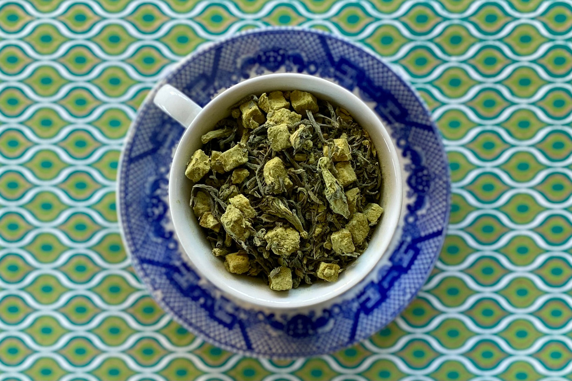 Teacup full of matcha-dusted tea leaves