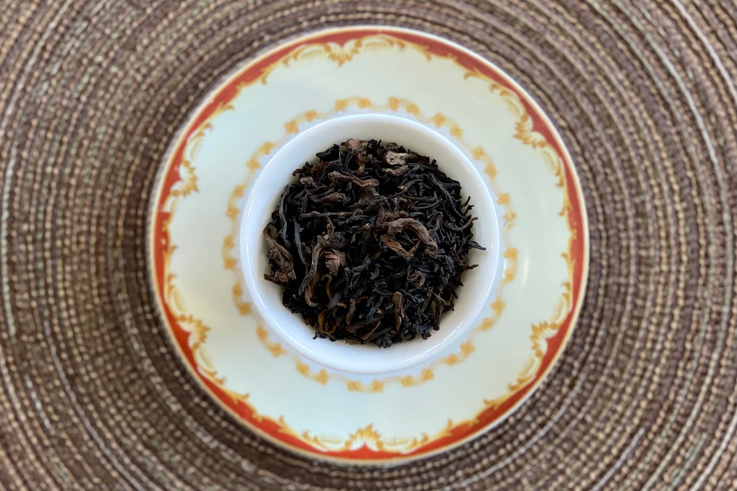 Teacup full of dark tea leaves