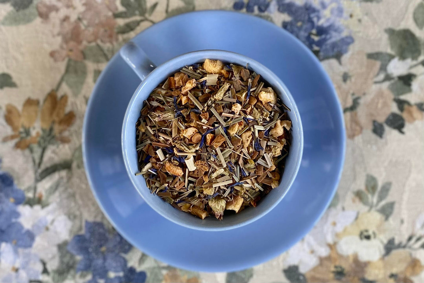 teacup full of fruits, spices, and lemongrass