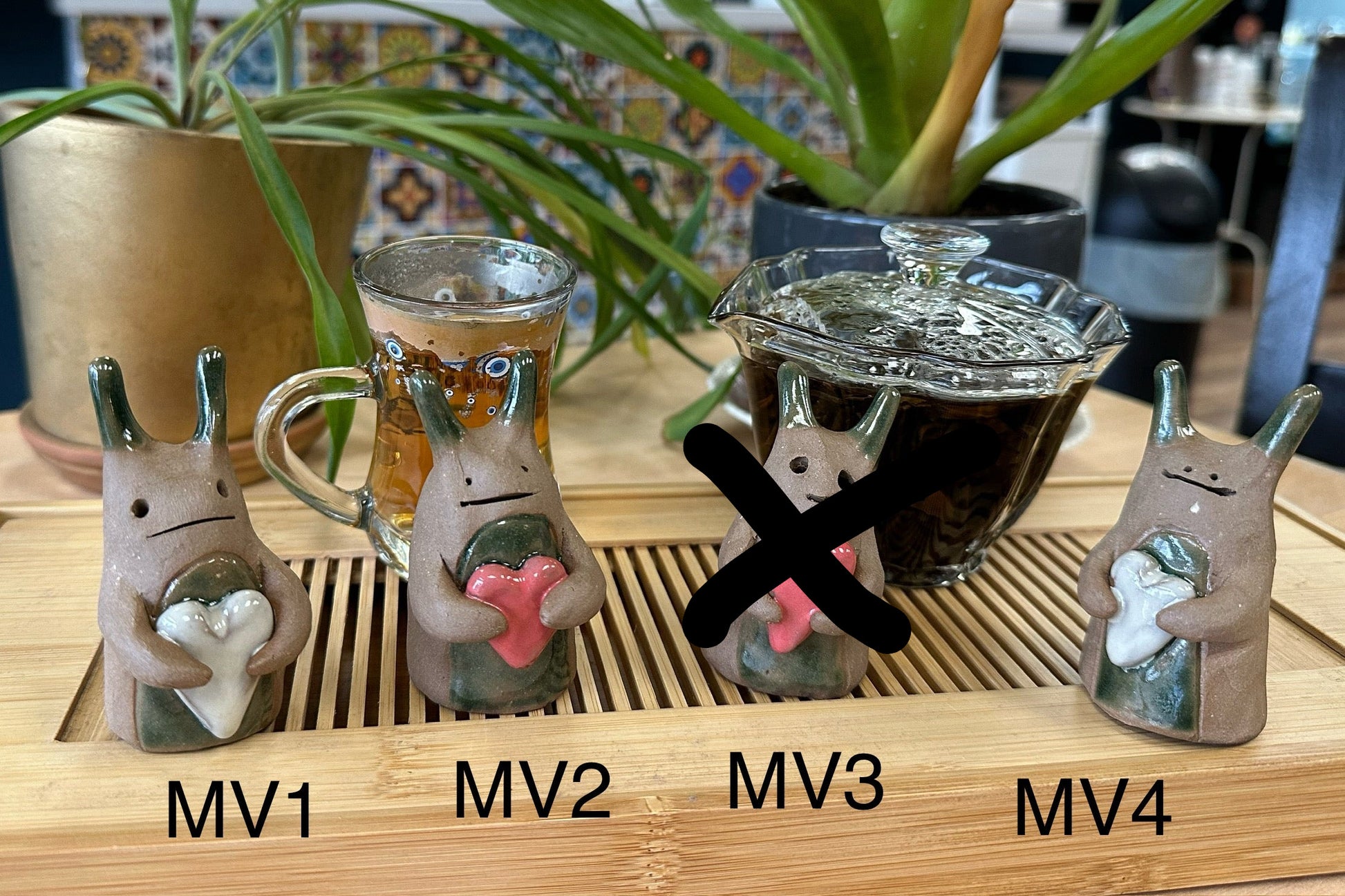 Four slug-type tea pets with hearts numbered MV1-MV4