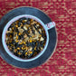 teacup full of dark oolong leaf and rich warm spices