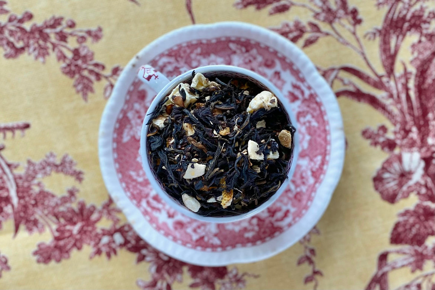 teacup full of black tea with peach, citrus, and ginger