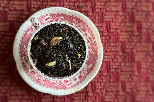 teacup full of black tea and pistachio