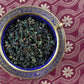 teacup full of rolled oolong and spices