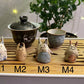 Five slug demon lookin tea pets on a bamboo tea tray