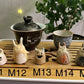 Five slug demon lookin tea pets on a bamboo tea tray