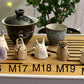 Five slug demon lookin tea pets on a bamboo tea tray