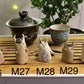 Five slug demon lookin tea pets on a bamboo tea tray
