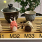 Four slug demon lookin tea pets on a bamboo tea tray