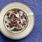 teacup full of rolled oolong tea, rose petal and coconut