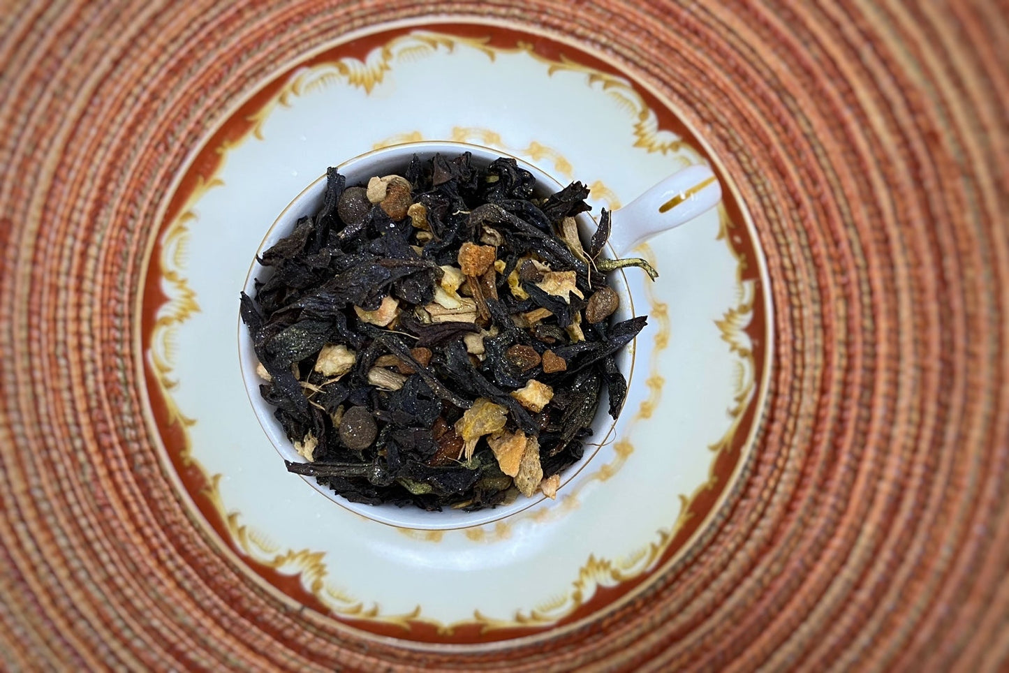 Teacup full of dark oolong leaf and spices